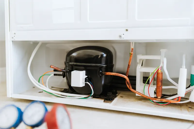 Newly installed refrigerator compressor with fresh brazed copper joints and a new filter-drier